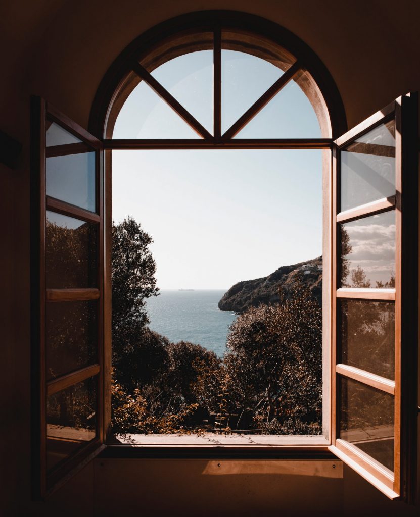 Photograph out of a window looking on a coastal region